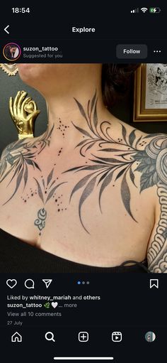 the back of a woman's chest with tattoos on it