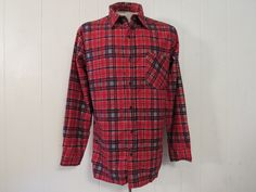 "Vintage 1970s shirt. Made of blue and red plaid cotton flannel. Features a button front, chest pocket and button cuffs. Label is missing. Size large. Actual measurements are: 45\" around the chest, 44\" at the waist, 19\" shoulder seam to shoulder seam, 24\" shoulder seam to end of cuff, 30\" overall length. In excellent unused condition. New old stock." Vintage Flannel Relaxed Fit Top, Vintage Flannel Top With Relaxed Fit, Vintage Relaxed Fit Flannel Top, Vintage Plaid Cotton Flannel Shirt, Vintage Flannel Shirt With Relaxed Fit, Vintage Red Flannel Shirt For Fall, Vintage Relaxed Fit Flannel Shirt For Winter, Vintage Collared Flannel Shirt, Vintage Red Flannel Shirt