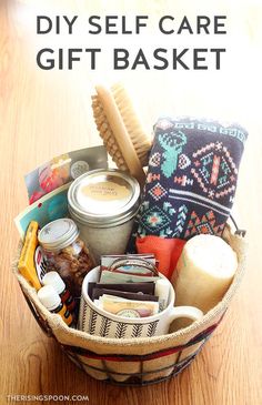 a basket filled with lots of different items on top of a wooden table text reads diy self care gift basket