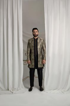 Upgrade your style with our Black and Gold Prince Coat. Made from luxurious brocade material, this front open coat exudes royalty. Paired with an Indian raw silk kurta pajama, it's the perfect ensemble for any formal event. Elevate your look and make a statement with this unique and elegant piece. 3-Piece Suit Designer Long Sleeve Sherwani For Festive Occasion, Designer Silk Fitted Outerwear, Fitted Silk Outerwear, Elegant Traditional Drape Outerwear For Party, Elegant Party Outerwear With Traditional Drape, Designer Straight Kurta Bandhgala For Ceremonial Occasions, Formal Festive Bandhgala With Resham Embroidery, Designer Ceremonial Bandhgala With Straight Kurta, Formal Bandhgala With Resham Embroidery For Festive Occasions