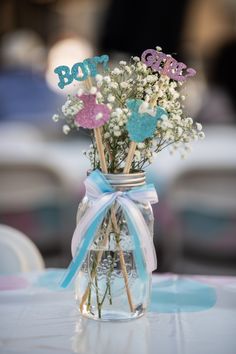 a vase filled with baby's breath sitting on top of a table