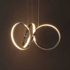 two rings suspended from strings with lights in the middle and one ring on each end