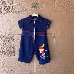 Vintage Baby Dark Blue Zip Up Baseball Jumpsuit  Condition: Good Size: 6-9 Months Measurements: Top to Bottom: 18.5" Pit to Pit: 9" Playful Blue Short Sleeve Bodysuit, Spring Blue Jumpsuits And Rompers For Playwear, Playful Fitted Blue Jumpsuits And Rompers, Blue Onesie For Playwear In Spring, Spring Blue Onesie For Playwear, Blue Short Sleeve Onesie For Playwear, Blue Spring Onesie For Playwear, Blue Short Sleeve Onesie For Playtime, Playful Blue Cotton Jumpsuits And Rompers