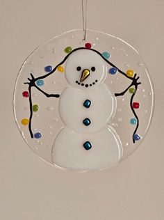 a glass ornament with a snowman on it