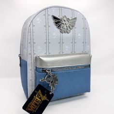 a white and blue backpack with a harry potter keychain