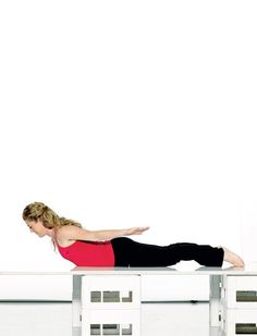 a woman is doing an exercise on a table