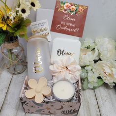 a gift box with flowers, candles and greeting cards