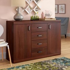 a wooden cabinet with drawers and a lamp next to it on a carpeted floor