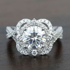 a diamond ring on top of a wooden table with diamonds in the middle and around it