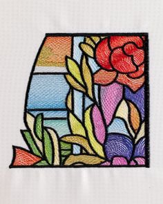 an embroidery design with flowers and leaves on it