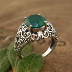 ...4 carats of rich green show! Be a head-turner with this sterling silver designer green onyx ring we appropriately named - Envy Ring! Its green onyx center and extravagant filigree details will have you feeling like royalty. The ring measures about 16mm in the front and tapers down to 1.75mm in the back. The round faceted green onyx center measures 10mm - 4 carats of rich green show! Perfect for adding a touch of flair to any outfit, this ring's captivating color and design is sure to get noti Rich Green, Onyx Ring, 50th Gifts, Green Onyx, Personal Marketing, Free Giveaway, Nature Beauty, Sterling Silver Jewelry, Onyx