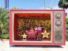 a woman standing in front of a tv with stars on it