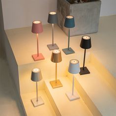 several different colored lamps on display in a room