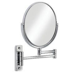 a wall mounted magnifying mirror on a white background