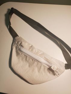 a white purse sitting on top of a table