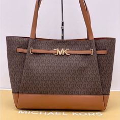 Brand New With Tag Michael Kors Reed Large Tote Bag Tote Bag Logo-Print Canvas Pvc And Leather Trim Color: Signature Brown And Luggage Gold-Tone Hardware 16.5"(Top) X 13"(Bottom) X 10.75"H X 7"D Handle Drop: 11.5" Interior Details: Back Zip Pocket, Front Slip Pocket Lining: 100% Polyester Snap Fastening Imported Tan Shoulder Bag With Large Capacity In Coated Canvas, Michael Kors Double Handle Bags For On-the-go, Tan Coated Canvas Bag With Handles, Tan Coated Canvas Bag, Coated Canvas Satchel With Branded Hardware, Michael Kors Tote Satchel For On-the-go, Double Handle Shopping Bag With Branded Hardware, Michael Kors Tote Satchel With Top Carry Handle, Tan Coated Canvas Bags With Branded Hardware