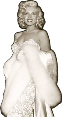 an old photo of a woman in a white dress and fur stole with her hands on her hips