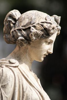 a statue of a woman with braids on her hair