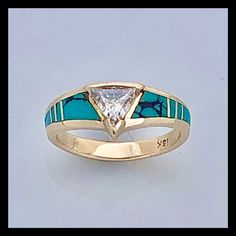 a yellow gold ring with blue and white stones