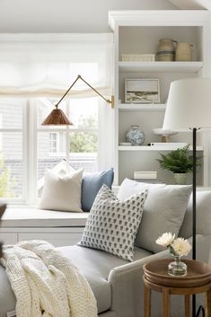 a living room filled with furniture and pillows