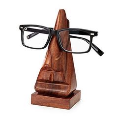 a pair of glasses sitting on top of a wooden stand