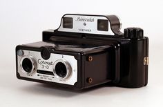 an old fashioned camera sitting on top of a table