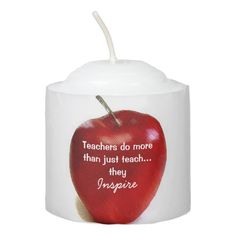 a white candle with an apple painted on it and the words teachers do more than just teach they inspire