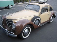 an old car is parked in a parking lot