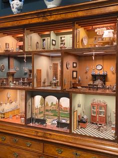 a display case filled with lots of wooden furniture