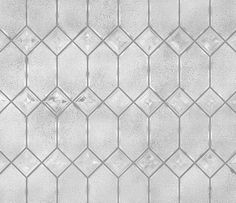 a white tiled wall with small squares on it