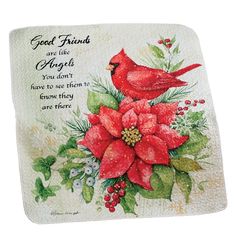 a red bird sitting on top of a poinsettia with holly and berries