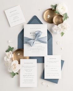 the wedding stationery is laid out and ready for guests to arrive