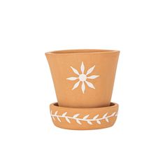 two clay pots with white designs on them