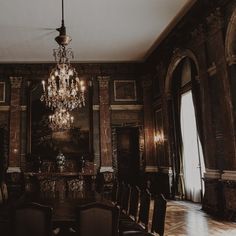 an ornate dining room with chandelier and chairs