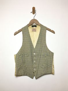 Just so good. Old wool vest with label intact. Gender neutral. As found, aged to perfection. Fabric: WoolLabel: Tattersall for Raleigh HaberdasherFit: M Measurements (flat): Armpit to armpit 19.5 inches Shoulder (across) 10.5 inches Arm opening 11.5 inches Length (back) 20.5 inches Waist 18.5 inches Condition: Good. Several small holes, some stains. Fitted Wool Vest Top, Tailored Vintage Fall Vest, Vintage Vest For Tailoring In Fall, Vintage Tailored Vest For Fall, Vintage Vest For Fall Tailoring, Classic Plaid Vest, Classic Plaid Sleeveless Vest, Classic Wool Vest For Spring, Vintage Wool Sleeveless Sweater Vest