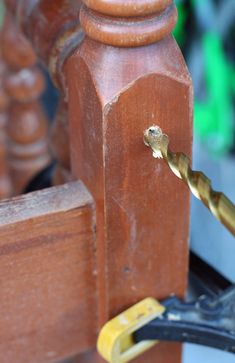 a close up of a piece of wood with a screwdriver attached to it