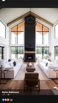 a large living room with high ceilings and wooden floors