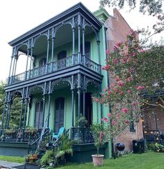 a large green house sitting on top of a lush green field