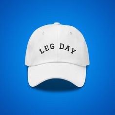 "This comfy and stylish Leg Day hat is sure to be a true favorite. The trendy dad hat embroidered Leg Day design stands out and is the perfect \"topping\" to complete any outfit. This popular embroidered gym baseball cap makes a great gift for any gym rat. Leg Day dad hat comes in multiple colors! Enjoy your leg days! * 100% chino cotton twill * Unstructured, 6-panel, low-profile * 6 embroidered eyelets * 3 ⅛\" (7.6 cm) crown * Adjustable strap with antique buckle (One size fits most) Colors may Sporty Hat With Letter Print And Curved Brim, Sporty Curved Brim Hat With Letter Print, White Dad Hat With Letter Print And Flat Bill, Sporty Hat With Curved Bill And Letter Print, Sporty Fitted Hat With Letter Print Curved Brim, One Size Fits Most Dad Hat With Letter Print, Sporty Dad Hat With Letter Print And Curved Brim, White Dad Hat With Letter Print For Sports Events, Sporty Cap With Letter Print