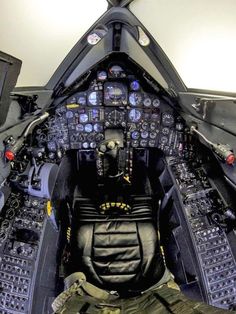 the cockpit of an airplane with many controls