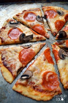 a pizza with pepperoni and mushrooms is cut into eight slices