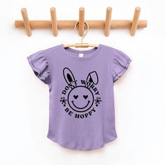 Looking for a cute tee for your daughter? We have the perfect flutter sleeve graphic tee. Cute Purple Top With Graphic Print, Cute Lavender Cotton Top, Purple Cartoon Print Tops For Spring, Cute Purple Top With Letter Print, Spring Lavender Letter Print Top, Playful Purple Tops With Cartoon Print, Playful Purple Short Sleeve Tops, Lavender Relaxed Fit Graphic Tee, Cute Purple Spring T-shirt