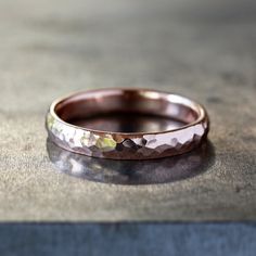 This hammered gold ring has a timeless style that will last for generations, perfect for a wedding band. The band is 4mm in width and 2mm thick, comfort fit, and available in either 14k rose gold (as shown in the photos) or 14k yellow gold. The exterior is hammered with a faceted pattern to create shimmering details, while the interior remains smooth. This is a striking and simple ring, perfect for everyday wear. Elegant Hammered Bands For Anniversary, Wedding Bands With Hammered Round Shape, Anniversary Rose Gold Hammered Stackable Rings, Classic Hammered Stackable Wedding Rings, Hammered Thick Band For Anniversary, Hammered Rose Gold Stackable Rings For Wedding, Wedding Stackable Hammered Rose Gold Rings, Rose Gold Hammered Round Band Rings, Hammered Rose Gold Round Band Jewelry