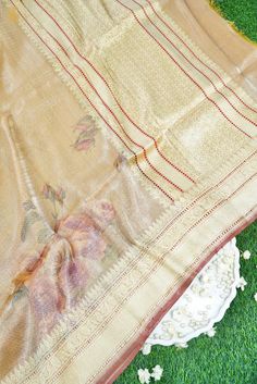 This is an exclusive limited edition in Silk and tissue fabrics with an elaborately crafted zari border. The combination of both silk and tissue fabrics makes it a stunning piece. Luxury Tissue Silk Dupatta For Summer, Gold Raw Silk Blouse With Sheer Dupatta, Gold Raw Silk Saree With Sheer Dupatta, Luxury Gold Saree, Festive Luxury Gold Saree, Luxury Festive Gold Saree, Celebration Tussar Silk Blouse With Dupatta, Elegant Sheer Dupatta In Tussar Silk, Elegant Tussar Silk Dupatta