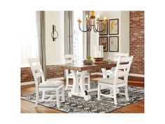 a dining room table with white chairs around it