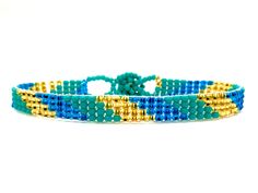 "Perfect for a pop of color! This turquoise \"skinny\" bracelet will charm your way through the day. Made using brilliant glass seed beads and premium nylon, these bohemian styled bracelets are dressed to impress and are a must-have every day accessory! Makes for a great birthday gift, Christmas gift, holiday gift, stocking stuffer, friendship bracelet and especially a \"just because\" gift for mom! Delicately handmade in Guatemala *Please note that all of our items are handcrafted and unique to Adjustable Turquoise Wrap Bracelet For Festival, Turquoise Beaded Friendship Bracelets For Summer, Bohemian Blue Friendship Bracelets For Summer, Blue Bohemian Friendship Bracelets For Summer, Turquoise Friendship Bracelets For Summer Festival, Turquoise Friendship Bracelets With Colorful Beads For Summer, Turquoise Friendship Bracelets With Tiny Beads For Summer, Trendy Turquoise Bracelets With Tiny Beads, Turquoise Summer Friendship Bracelet With Tiny Beads