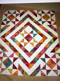 an image of a colorful quilt on the floor