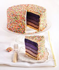 there is a cake with sprinkles on the top and one slice missing