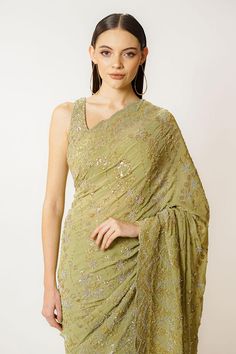 Olive green georgette saree with sequins and cutdana hand embroidery. Comes with a blouse.
Components: 2
Pattern: Hand embroidered
Type Of Work: Sequins, Cutdana
Neckline: Round
Sleeve Type: Sleeveless
Fabric: Georgette
Color: Green
Other Details: 
Closure: Blouse - Back hooks and tie-up
Occasion: Wedding - Aza Fashions Semi-stitched Sleeveless Georgette Pre-draped Saree, Evening Green Blouse Piece With Sheer Dupatta, Green Pre-draped Saree With Sheer Dupatta For Evening, Green Sleeveless Pre-draped Saree For Festive Season, Green Blouse Piece For Evening With Traditional Drape, Georgette Pre-draped Saree With Sequins For Reception, Green Blouse Piece With Dupatta For Evening, Green Cutdana Pre-draped Saree For Evening, Reception Georgette Pre-draped Saree With Sequins