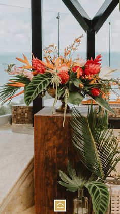 a vase filled with flowers sitting on top of a wooden box